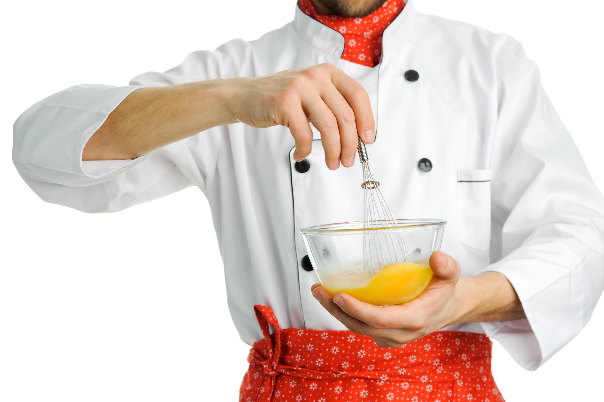 Chef demonstrating a technique in a compact kitchen